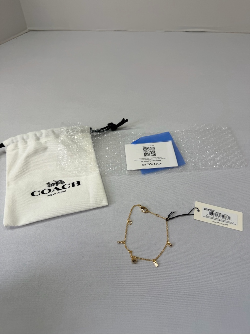 Coach Gold-Tone Mini Charm Bracelet with Dangling Accents